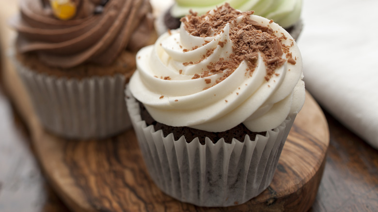Trio of cupcakes on wood